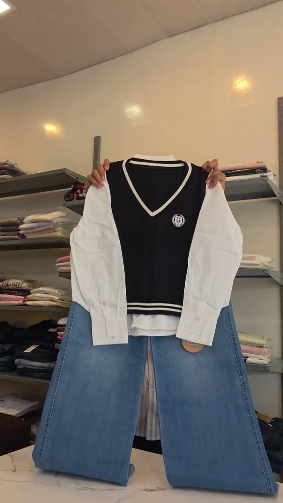 Women’s Trendy Navy Sleeveless V-Neck Sweater Vest Layered Over White Button-Down Shirt with Light Blue Wide-Leg Denim Jeans for Stylish Preppy Casual Co-Ord Fashion